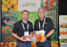 Cornelius Neufeld and Ray Wowryk with NatureFresh Farms show cherry tomatoes on-the-vine and long sweet peppers.